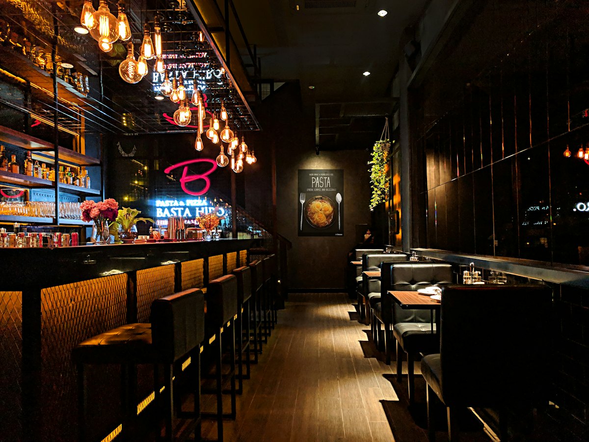 A long, dim bar with stools